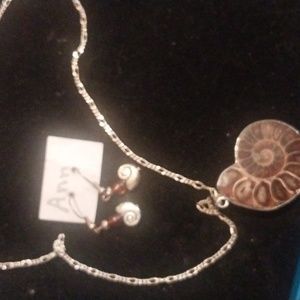silver necklace with a snail pendant and matching earrings